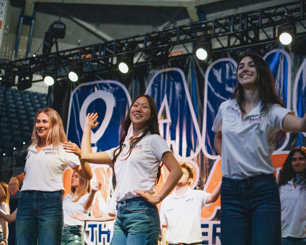 Our 2027 Executive Director, Ashley Paek (left) and our 2027 Marketing Manager, Marina Cheema (right) doing the signature Linedance at our 2026 Main Event.